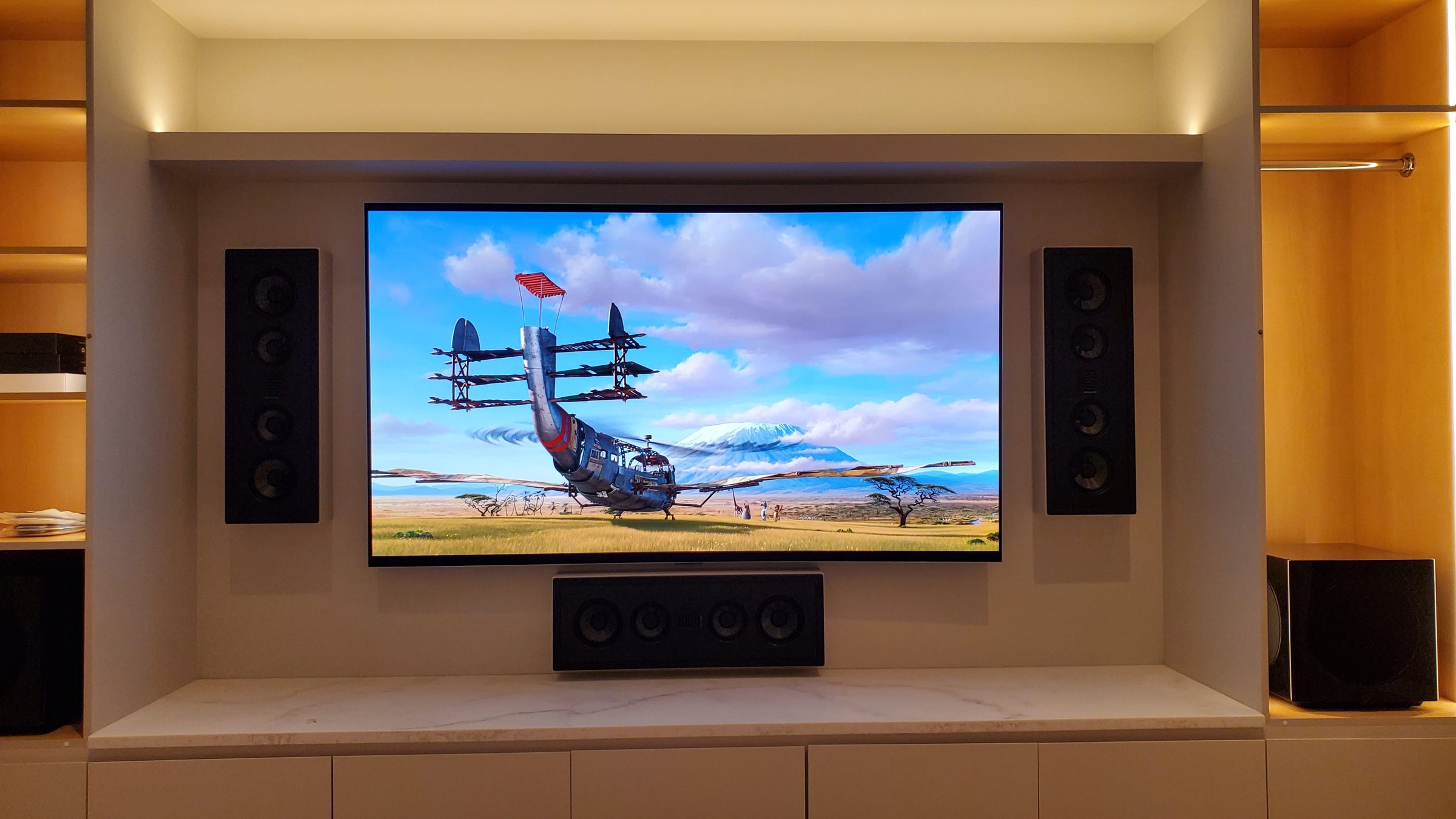 Stealth media wall with in-wall left and right speakers, centre channel and subwoofer visible
